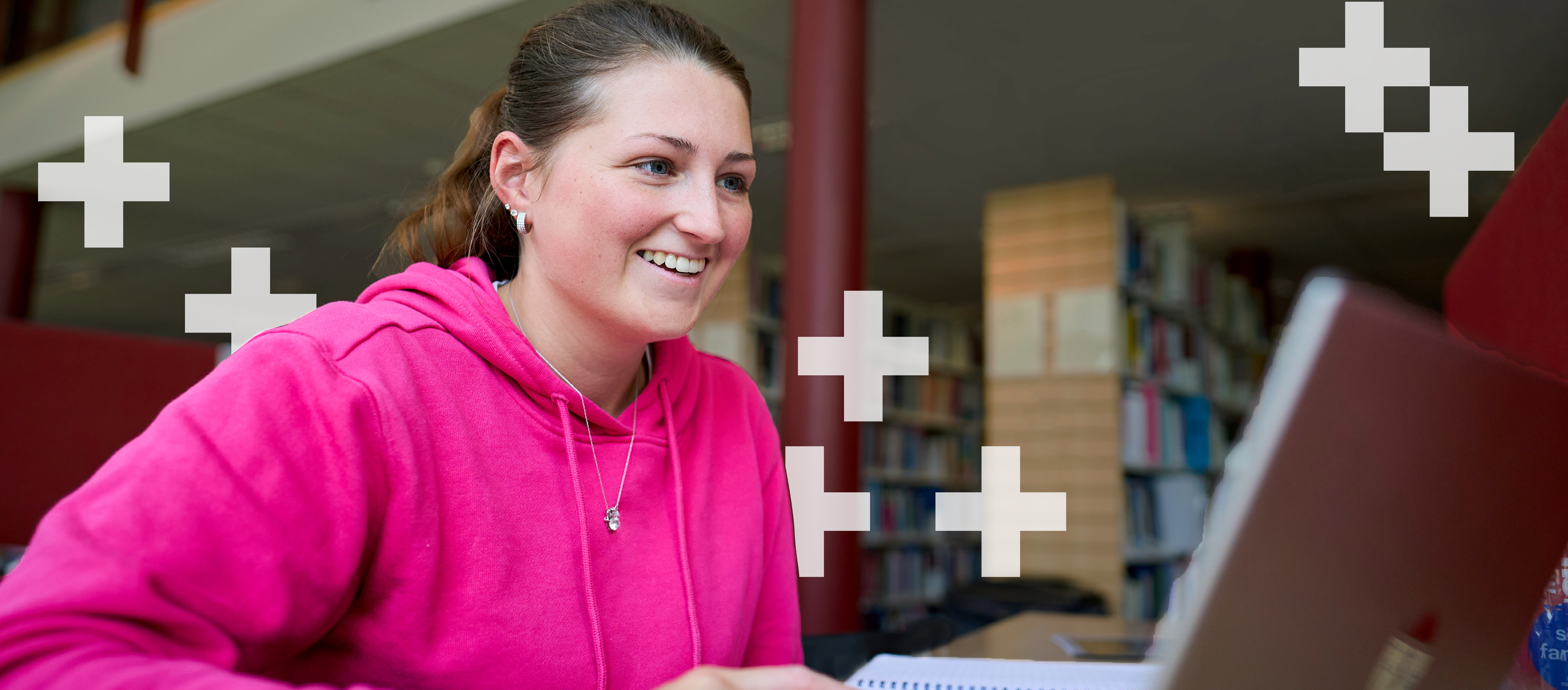 Girl in pink hoody on laptop Girl in pink hoody on laptop