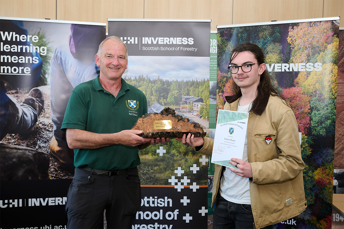 Two men holding an award and certificate