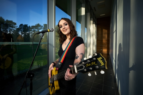 A person playing guitar A person playing guitar