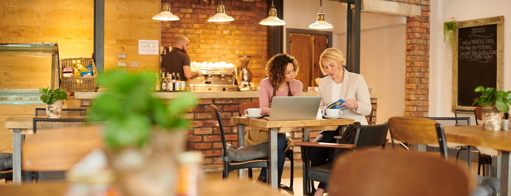 two women sitting at a computer