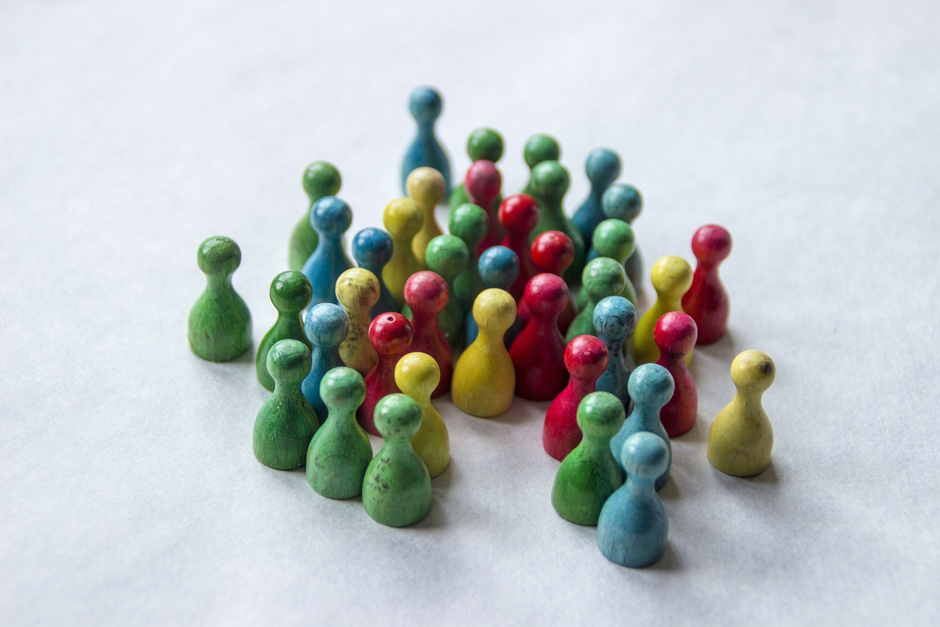 A cluster of board game pieces that look like people A cluster of board game pieces that look like people