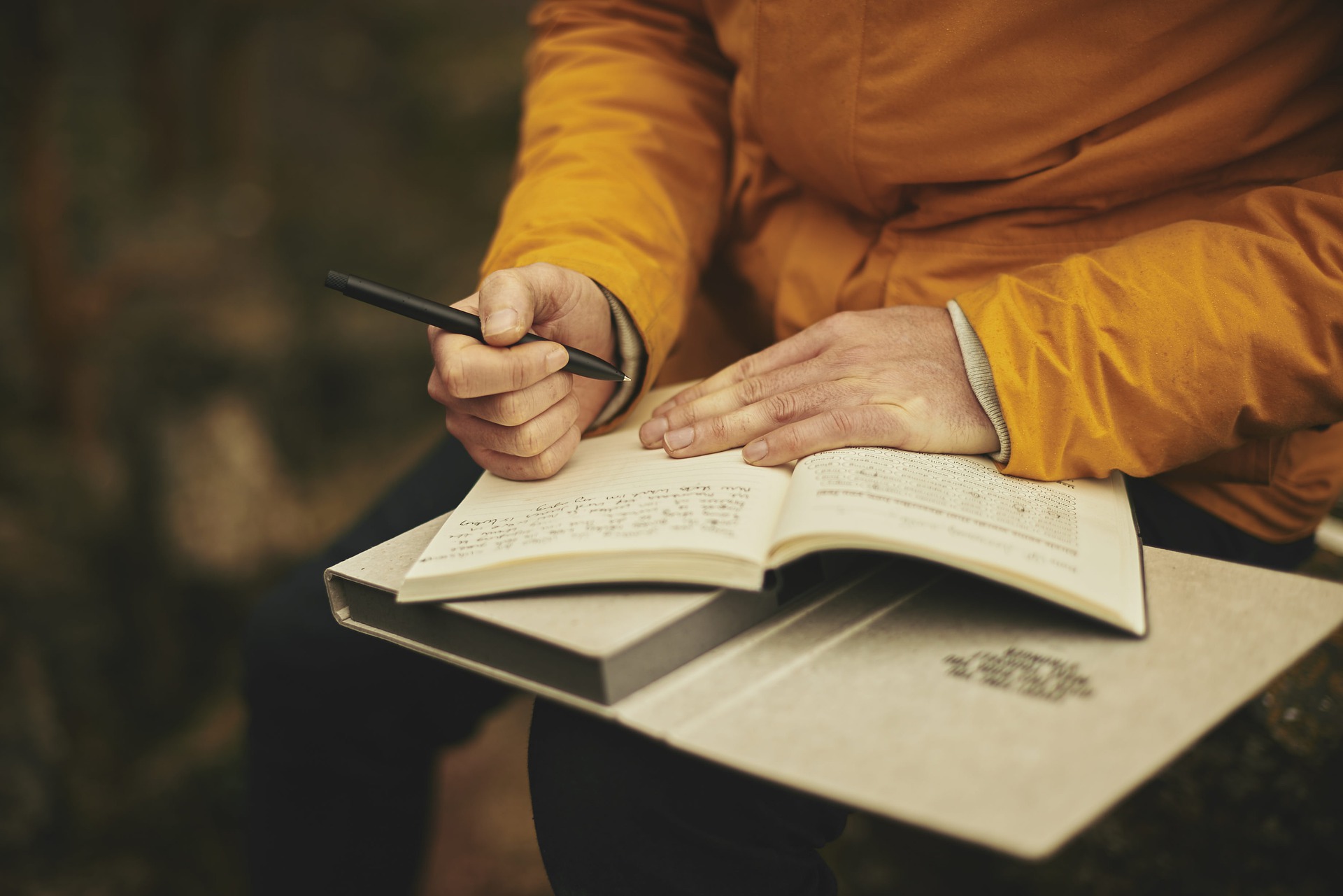 A person writing in a book A person writing in a book
