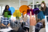 A finger pointing at multicoloured speech bubbles A finger pointing at multicoloured speech bubbles