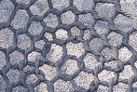 A rope net above some gravel A rope net above some gravel