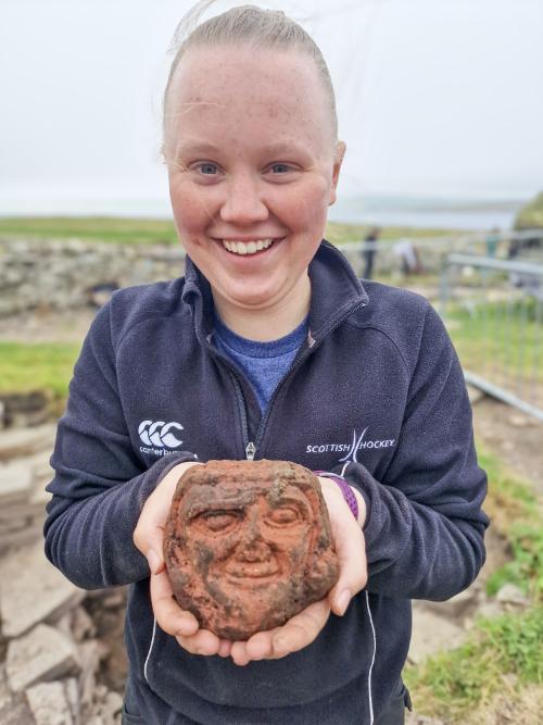 UHI Archaeology Institute undergraduate student Katie Joss with the Skaill carved head UHI Archaeology Institute undergraduate student Katie Joss with the Skaill carved head