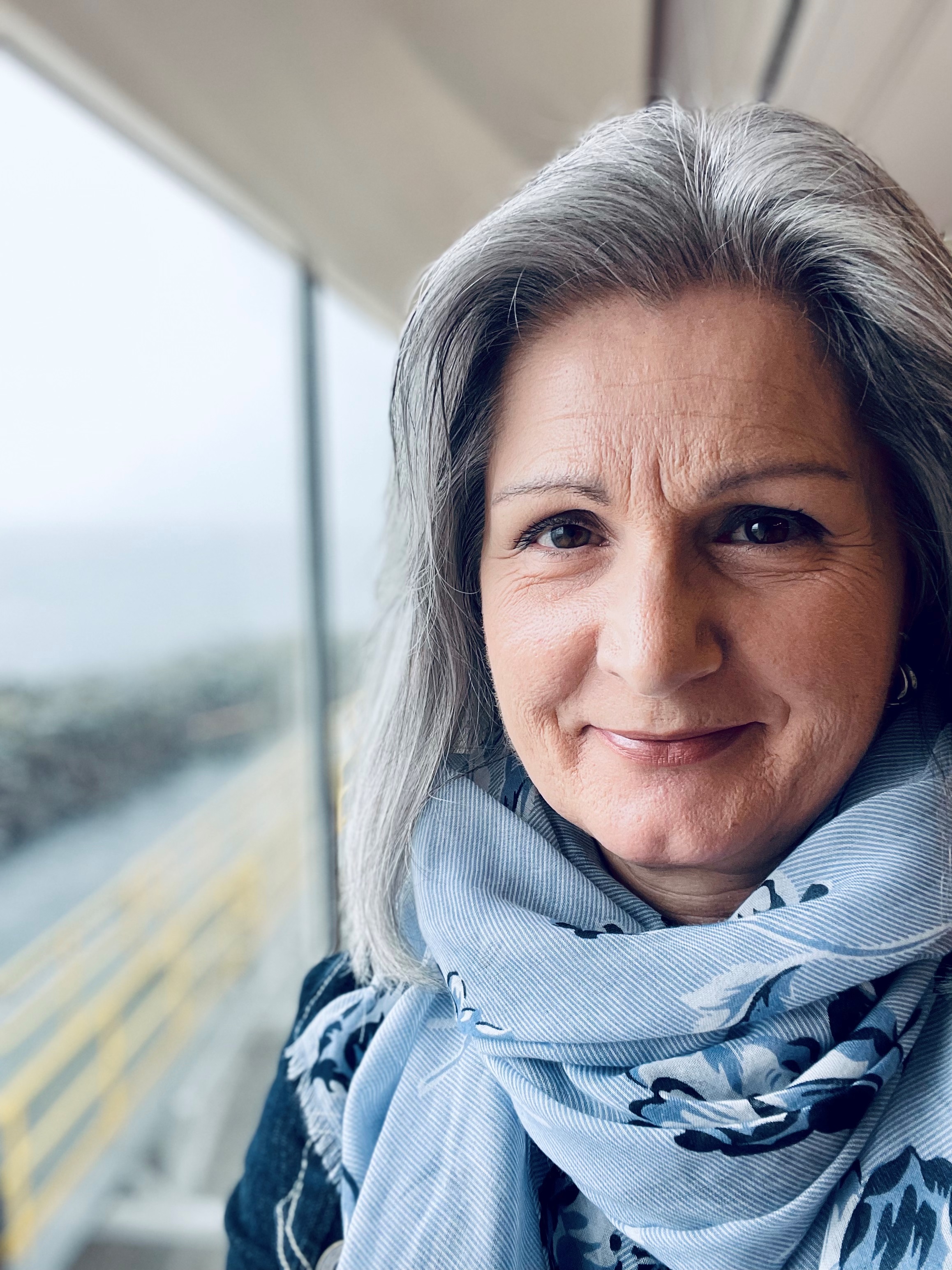 Close up photograph of a woman, with the background softly out of focus. Close up photograph of a woman, with the background softly out of focus.