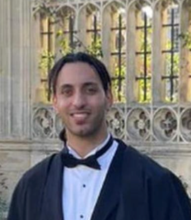 Man wearing a tuxedo and graduation gown. Man wearing a tuxedo and graduation gown.