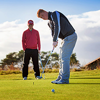 Two people playing golf Two people playing golf