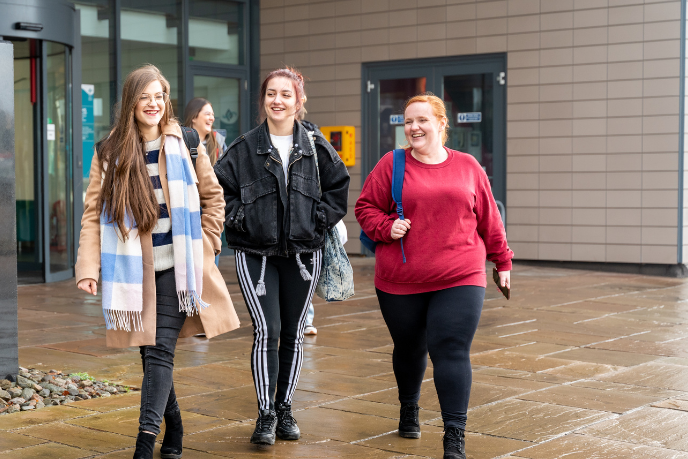 Students walking outside UHI House Students walking outside UHI House
